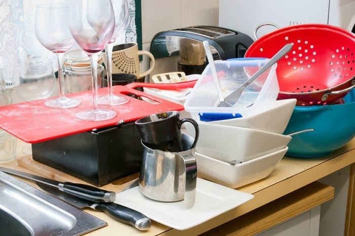 cleaning up dinner dishes on counter